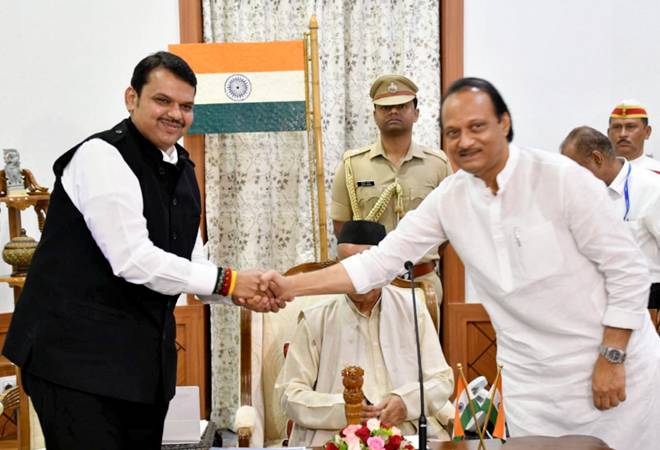 Newly-sworn in Chief Minister of Maharashtra Devendra Fadnavis shakes hands with his Deputy Chief Minister Ajit Pawar Newly-sworn in Chief Minister of Maharashtra Devendra Fadnavis shakes hands with his Deputy Chief Minister Ajit Pawar