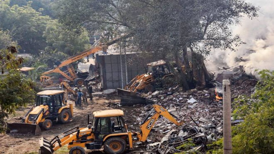 Delhi Peergarhi fire: A large portion of the two-storey building collapsed following an explosion when firefighters were dousing the blaze Delhi Peergarhi fire: A large portion of the two-storey building collapsed following an explosion when firefighters were dousing the blaze