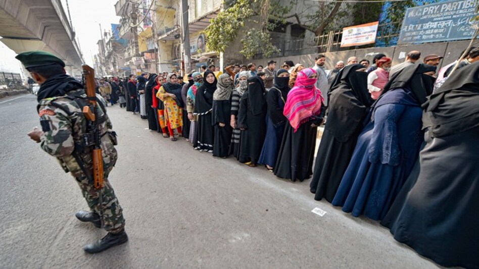 Delhi exit polls: Voters line up to cast their votes (Photo credit: PTI) Delhi exit polls: Voters line up to cast their votes (Photo credit: PTI)