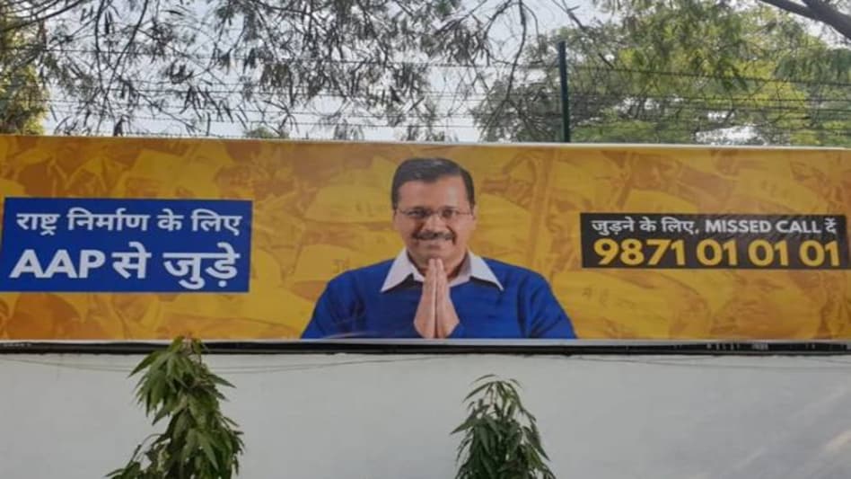 Delhi assembly election 2020: A poster of Arvind Kejriwal urging citizens to call on a helpline number to give their inputs for nation-building has been put up outside the AAP headquarters in Delhi Delhi assembly election 2020: A poster of Arvind Kejriwal urging citizens to call on a helpline number to give their inputs for nation-building has been put up outside the AAP headquarters in Delhi