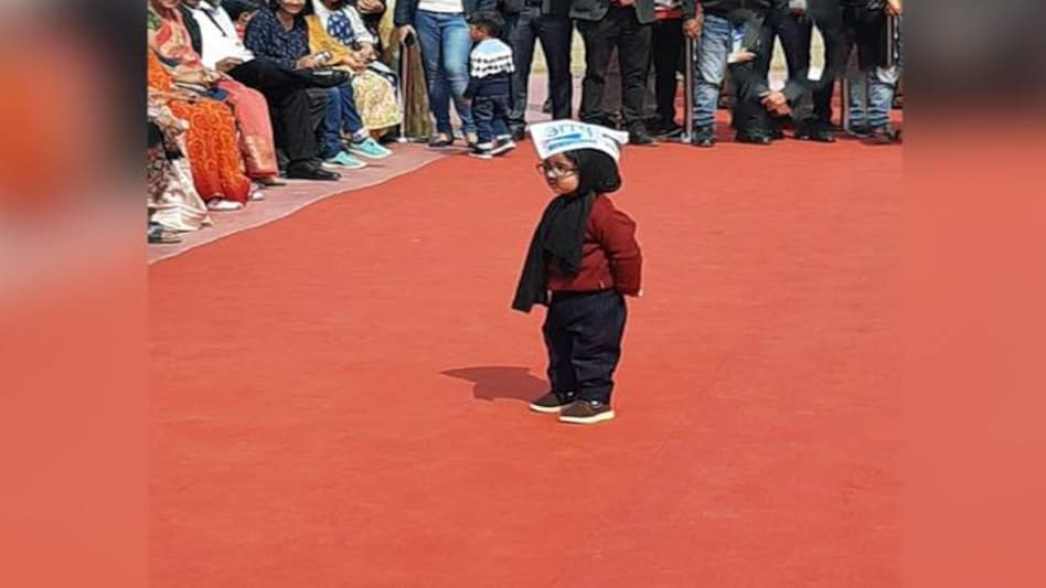 Arvind Kejriwal oath-taking ceremony: The one-year-old "Mufflerman", whose original name is Avyaan Tomar was first spotted at the AAP headquarters at ITO on February 11 Arvind Kejriwal oath-taking ceremony: The one-year-old "Mufflerman", whose original name is Avyaan Tomar was first spotted at the AAP headquarters at ITO on February 11
