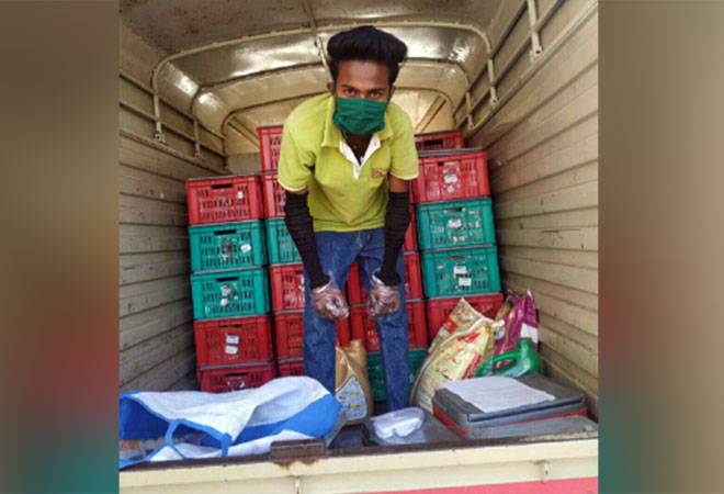 A bigbasket delivery staff delivering goods during lockdown (Twitter/BigBasket) A bigbasket delivery staff delivering goods during lockdown (Twitter/BigBasket)