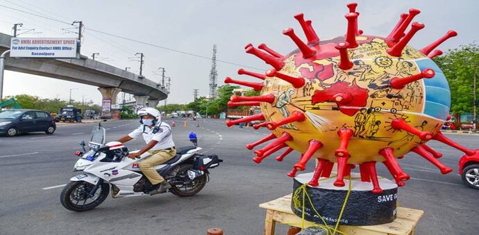 A policeman rides across the coronavirus statue in Hyderabad erected to spread awareness about the novel virus (Credits - PTI) A policeman rides across the coronavirus statue in Hyderabad erected to spread awareness about the novel virus (Credits - PTI)