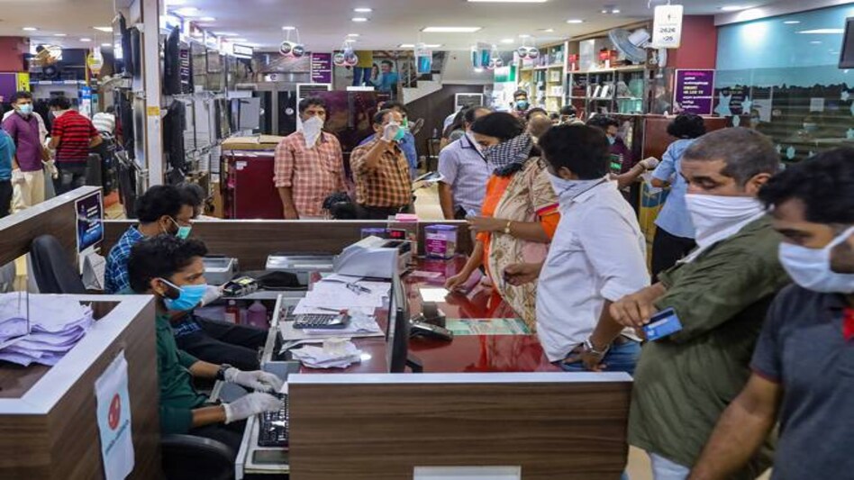 People purchase electrical items at a showroom on the opening day of a once in a week market, during ongoing COVID-19 lockdown in Kozhikode People purchase electrical items at a showroom on the opening day of a once in a week market, during ongoing COVID-19 lockdown in Kozhikode