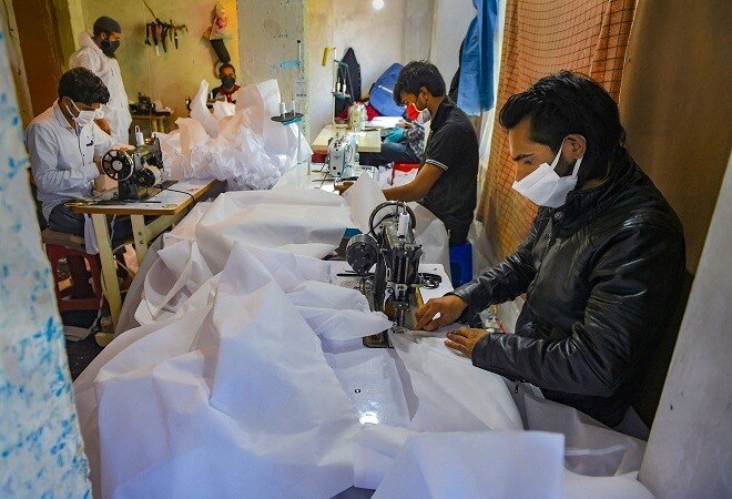 Workers in Srinagar build personal protective equipments, or PPEs (Photo credit: PTI) Workers in Srinagar build personal protective equipments, or PPEs (Photo credit: PTI)