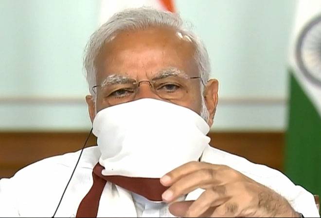 Prime Minister Narendra Modi wearing a protective mask chairs a meeting with chief ministers on COVID-19 lockdown via video conference. Prime Minister Narendra Modi wearing a protective mask chairs a meeting with chief ministers on COVID-19 lockdown via video conference.