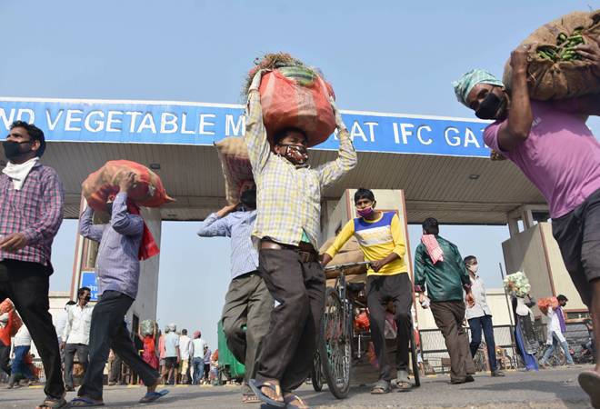 Vendors leave Ghazipur market after buying vegetables, during the ongoing coronavirus lockdown Vendors leave Ghazipur market after buying vegetables, during the ongoing coronavirus lockdown