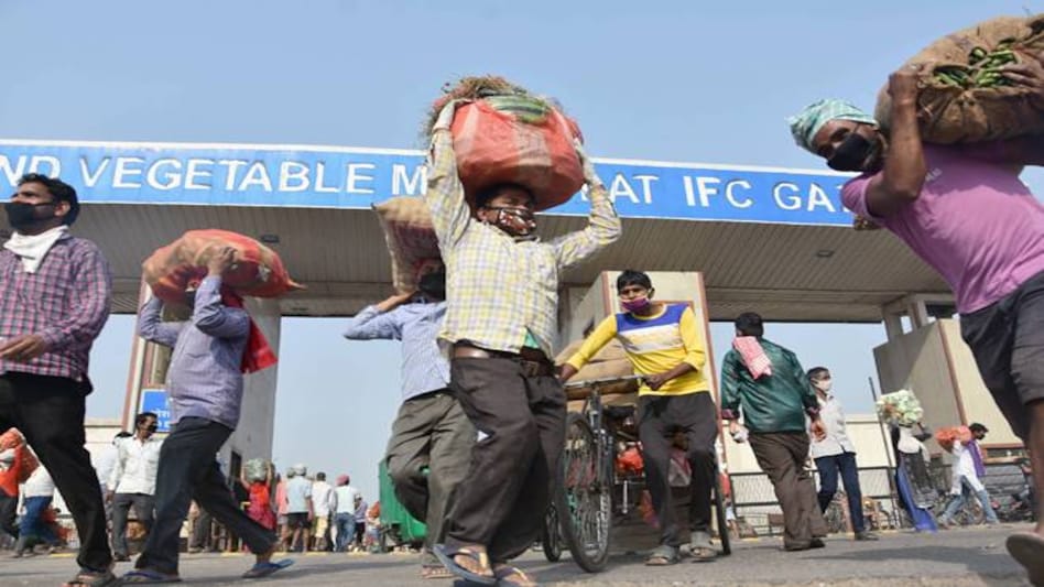 Vendors leave Ghazipur market after buying vegetables, during the ongoing coronavirus lockdown Vendors leave Ghazipur market after buying vegetables, during the ongoing coronavirus lockdown