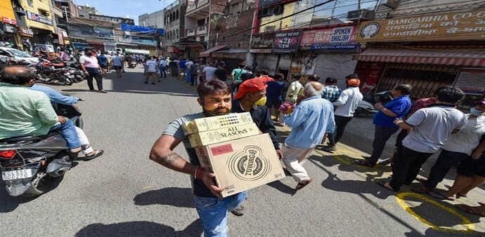 Coronavirus lockdown in Delhi: A customer carries alcohol after purchasing from a wine shop, during the ongoing COVID-19 nationwide lockdown, at Chander Nagar in East Delhi Coronavirus lockdown in Delhi: A customer carries alcohol after purchasing from a wine shop, during the ongoing COVID-19 nationwide lockdown, at Chander Nagar in East Delhi