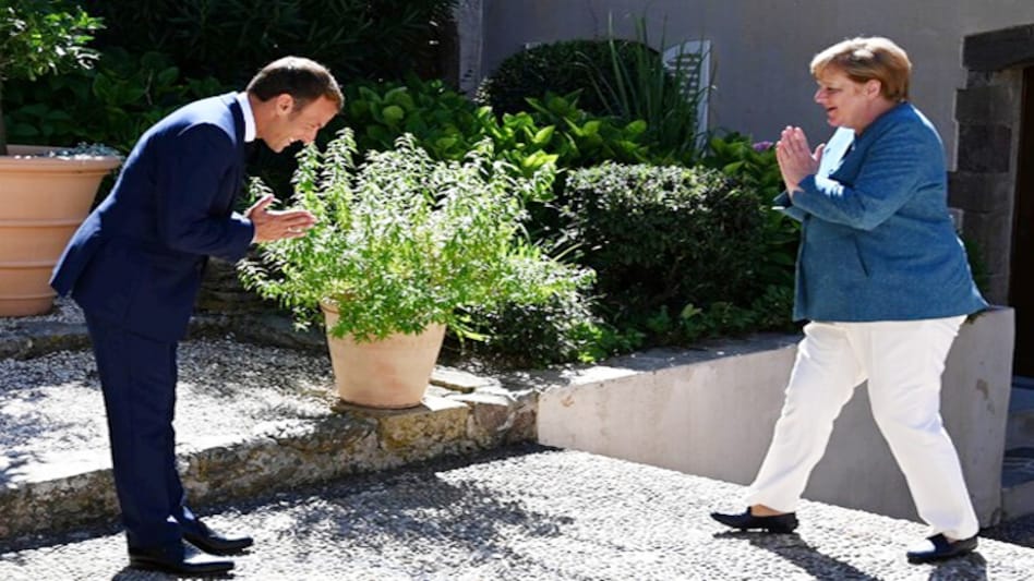 French President Emmanuel Macron and German Chancellor Angela Merkel greet each other using Namaste French President Emmanuel Macron and German Chancellor Angela Merkel greet each other using Namaste