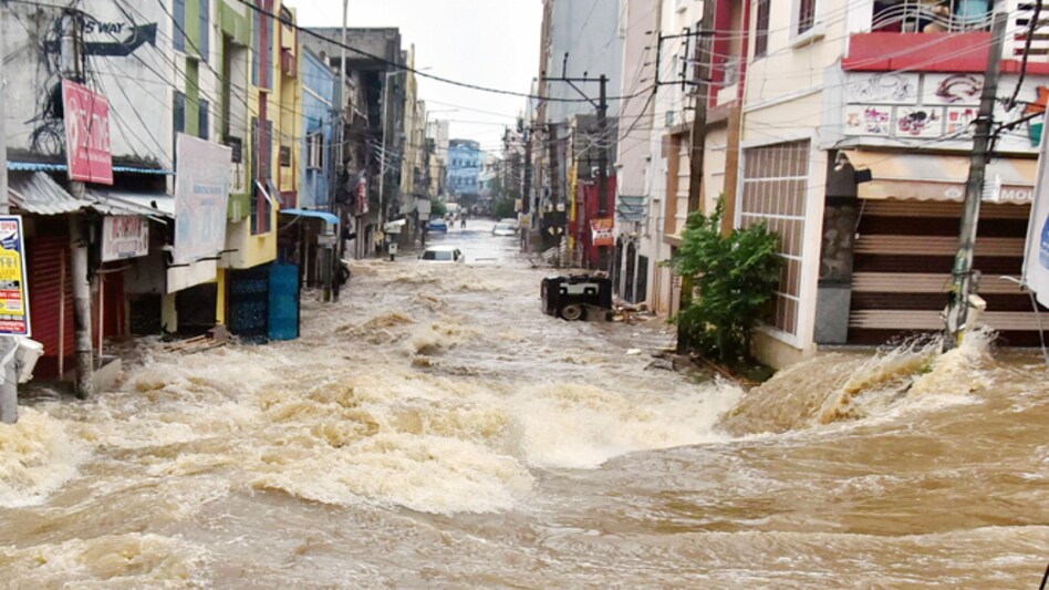 Hyderabad floods: Locals can also be heard shouting for help in the video, as two people standing on an elevated path are seen watching the man helplessly amid screams Hyderabad floods: Locals can also be heard shouting for help in the video, as two people standing on an elevated path are seen watching the man helplessly amid screams