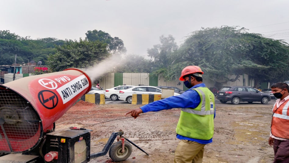 Workers use an anti-smog gun as a preventive measure to reduce air pollution in New Delhi Workers use an anti-smog gun as a preventive measure to reduce air pollution in New Delhi