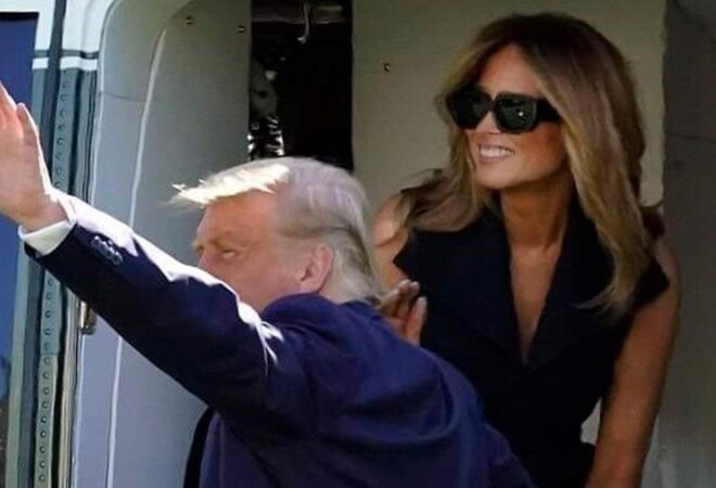 In the picture, Melania can be spotted wearing large sunglasses and sporting a huge grin which some Twitter users believed was not genuine and also did not match her usual subtle grin In the picture, Melania can be spotted wearing large sunglasses and sporting a huge grin which some Twitter users believed was not genuine and also did not match her usual subtle grin
