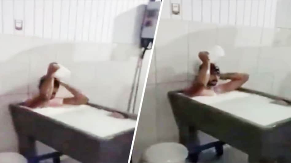 The footage shared on TikTok, shows a man sitting in a huge tub full of milk, and using a mug to pour milk all over his head The footage shared on TikTok, shows a man sitting in a huge tub full of milk, and using a mug to pour milk all over his head