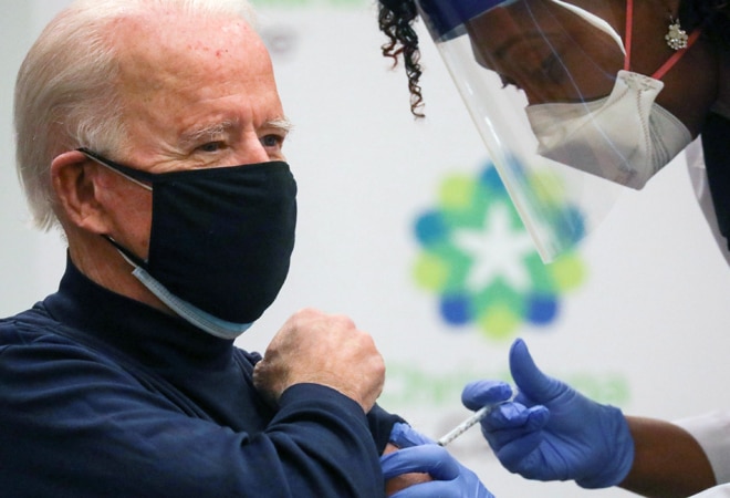 His black long-sleeved shirt rolled up, Biden received the injection from Tabe Masa, Nurse Practitioner and Head of Employee Health Services at Christiana Hospital in Newark, Delaware, in front of reporters His black long-sleeved shirt rolled up, Biden received the injection from Tabe Masa, Nurse Practitioner and Head of Employee Health Services at Christiana Hospital in Newark, Delaware, in front of reporters