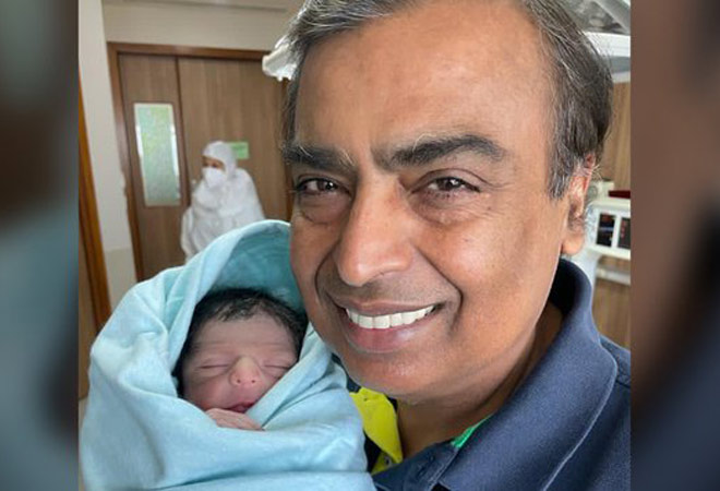 Mukesh Ambani poses for a snap with his newborn grandson Mukesh Ambani poses for a snap with his newborn grandson