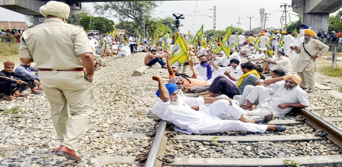 A group of farmers standing on top of trucks raise slogans during the ongoing protest against the Centers new farm laws, at Singhu border A group of farmers standing on top of trucks raise slogans during the ongoing protest against the Centers new farm laws, at Singhu border