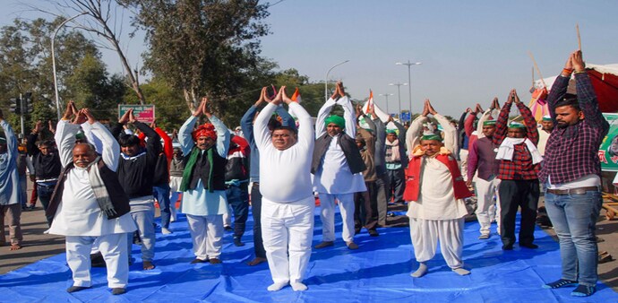 Farmers demonstrating against the Centre's new agri laws performed yoga on the Delhi-Noida Link Road (Image: PTI) Farmers demonstrating against the Centre's new agri laws performed yoga on the Delhi-Noida Link Road (Image: PTI)