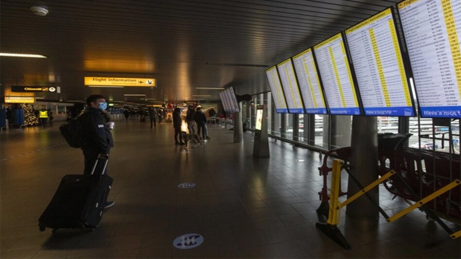 In this Friday December 18, 2020, file photo, a traveller wearing a face mask checks the flight departures at Schiphol Airport, near Amsterdam, Netherlands. (AP photo) In this Friday December 18, 2020, file photo, a traveller wearing a face mask checks the flight departures at Schiphol Airport, near Amsterdam, Netherlands. (AP photo)