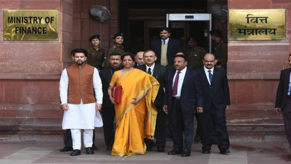 Finance Minister Nirmala Sitharaman holding the federal budget 2020 with Union Minister of State for Finance & Corporate Affairs Anurag Thakur and others Finance Minister Nirmala Sitharaman holding the federal budget 2020 with Union Minister of State for Finance & Corporate Affairs Anurag Thakur and others