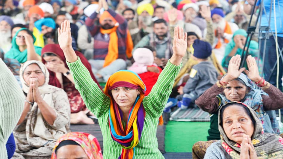 Farmers raise slogans during their ongoing protest at Singhu Border Farmers raise slogans during their ongoing protest at Singhu Border