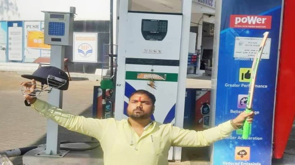 Man poses with cricket bat, helmet as premium petrol price hits a century in Bhopal Man poses with cricket bat, helmet as premium petrol price hits a century in Bhopal