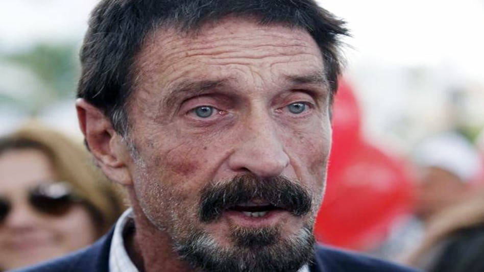 McAfee is being detained in Spain on separate criminal charges filed by the Justice Department's tax division McAfee is being detained in Spain on separate criminal charges filed by the Justice Department's tax division