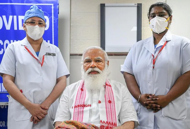 Prime Minister Narendra Modi after being administered the first dose of coronavirus vaccine, at AIIMS in New Delhi, March 1. Sister P Niveda (right) administered Covaxin to PM Modi. (PTI Photo) Prime Minister Narendra Modi after being administered the first dose of coronavirus vaccine, at AIIMS in New Delhi, March 1. Sister P Niveda (right) administered Covaxin to PM Modi. (PTI Photo)