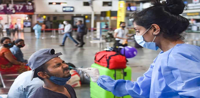 Covid cases in Maharashtra: A health worker takes a swab sample of a outstation passenger for COVID-19 tests amid the ongoing surge in coronavirus cases in Mumbai Covid cases in Maharashtra: A health worker takes a swab sample of a outstation passenger for COVID-19 tests amid the ongoing surge in coronavirus cases in Mumbai