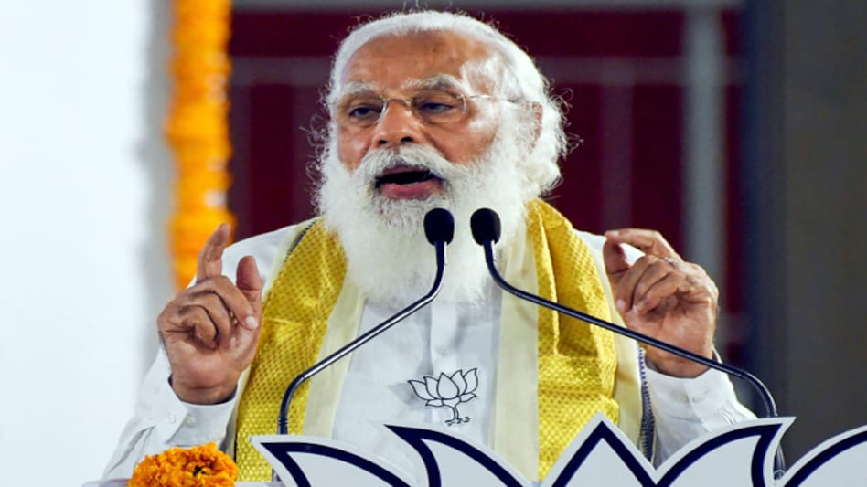PM Modi helps BJP worker at Assam election rally PM Modi helps BJP worker at Assam election rally