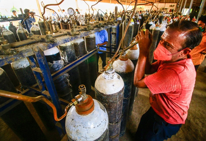 Workers refill oxygen cylinders before being transported to hospital for Covid-19 patients, amid the rise in Covid-19 cases across the country Workers refill oxygen cylinders before being transported to hospital for Covid-19 patients, amid the rise in Covid-19 cases across the country
