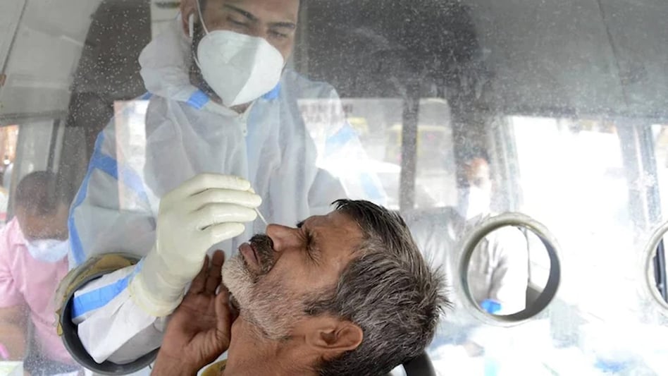 A health worker takes nasal swab of a person at a Covid testing centre in Amritsar. (Photo: PTI) A health worker takes nasal swab of a person at a Covid testing centre in Amritsar. (Photo: PTI)