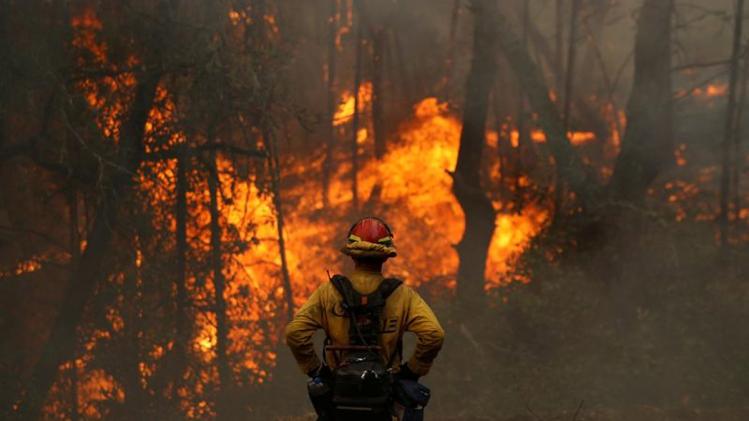 Firefighters struggle to contain advancing California wildfire as heat wave blankets US West