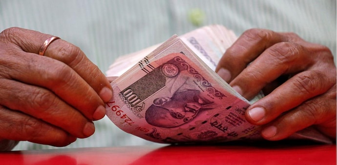 A man counts Indian currency notes inside a shop in Mumbai, India (Source:Reuters) A man counts Indian currency notes inside a shop in Mumbai, India (Source:Reuters)