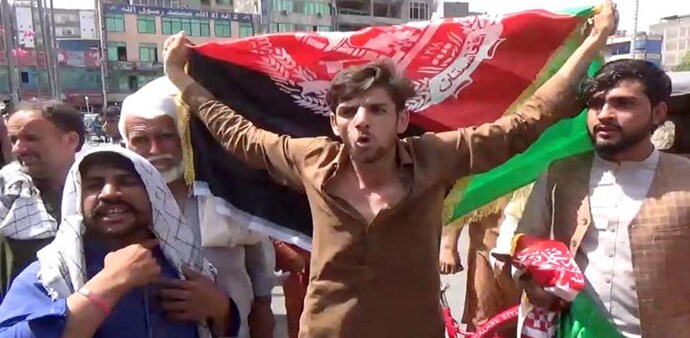 “Our flag, our identity,” a crowd of men and women waving black, red and green national flags shouted in Kabul (Source:Reuters) “Our flag, our identity,” a crowd of men and women waving black, red and green national flags shouted in Kabul (Source:Reuters)