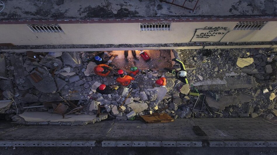 Mexican firefighters known as "Topos" work in the early morning hours in a search and rescue mission, amid the rubble from last week's 7.2 magnitude earthquake, in Les Cayes, Haiti Mexican firefighters known as "Topos" work in the early morning hours in a search and rescue mission, amid the rubble from last week's 7.2 magnitude earthquake, in Les Cayes, Haiti