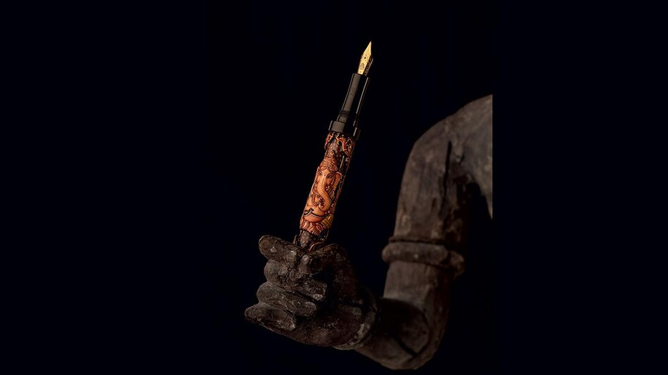 A lotus pen photographed on an 18th century crafted wood sculpture. Location courtesy of beyond designs A lotus pen photographed on an 18th century crafted wood sculpture. Location courtesy of beyond designs