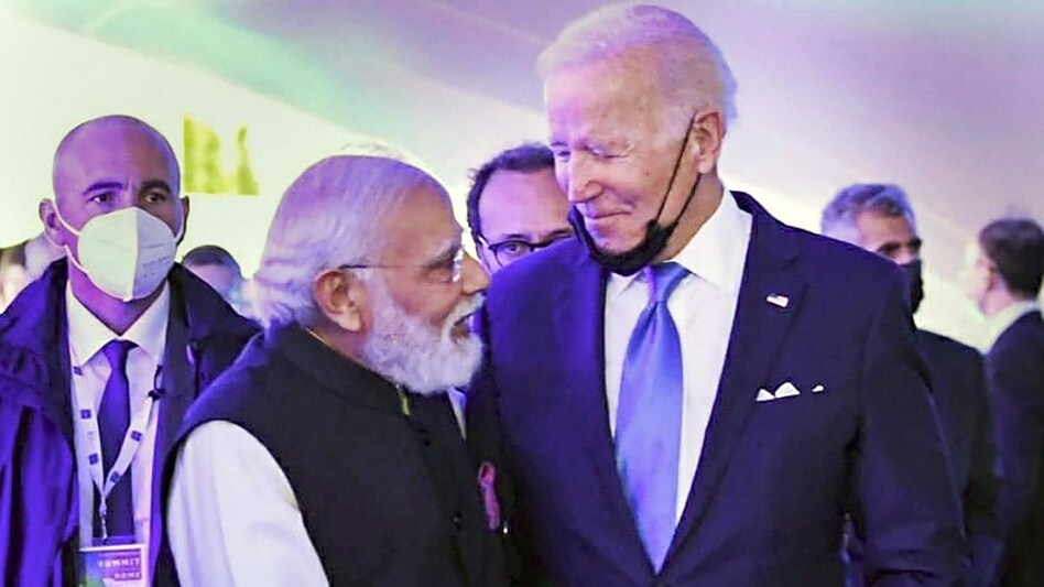 In the pictures, Modi is seen walking with Biden in a half embrace, apparently sharing a light chitchat. In the pictures, Modi is seen walking with Biden in a half embrace, apparently sharing a light chitchat.