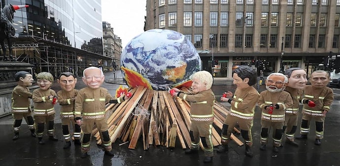 A delegate walks past a sign during the UN Climate Change Conference (COP26) in Glasgow, Scotland. (Photo: Reuters) A delegate walks past a sign during the UN Climate Change Conference (COP26) in Glasgow, Scotland. (Photo: Reuters)