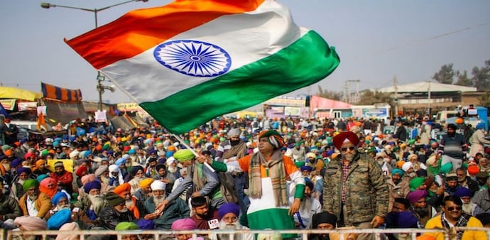 File photo of a farmer waving the Tricolor during a protest against the new farm laws at Singhu Border in New Delhi in 2020. (PTI Photo) File photo of a farmer waving the Tricolor during a protest against the new farm laws at Singhu Border in New Delhi in 2020. (PTI Photo)