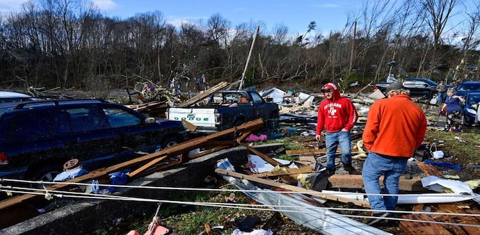 People survey the damage of the home of their grandmother, who was torn from the house and found in the street, after devastating tornadoes ripped through several US states, in Dawson Springs, Kentucky, US, December 11, 2021. People survey the damage of the home of their grandmother, who was torn from the house and found in the street, after devastating tornadoes ripped through several US states, in Dawson Springs, Kentucky, US, December 11, 2021.