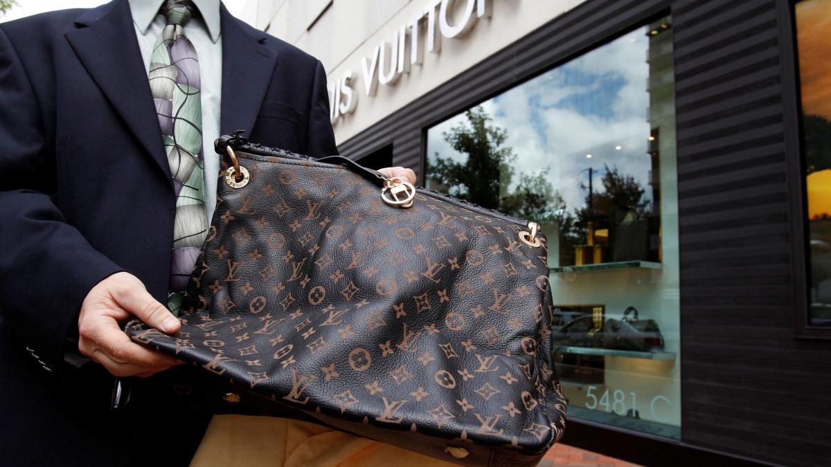 A fake LVMH handbag is displayed to the photographer outside a Louis Vuitton store in Chevy Chase. (Photo: Reuters) A fake LVMH handbag is displayed to the photographer outside a Louis Vuitton store in Chevy Chase. (Photo: Reuters)
