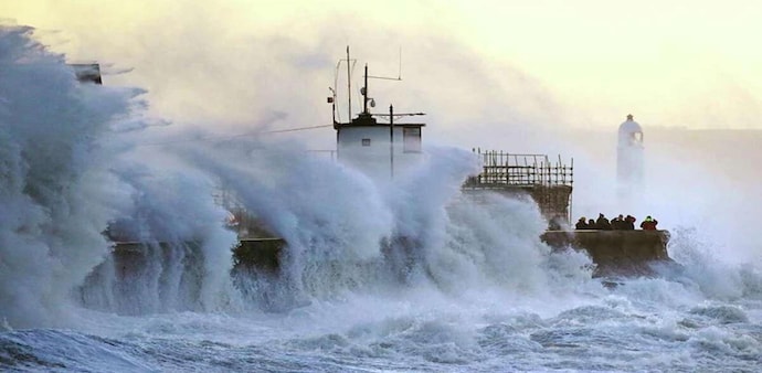Waves crash against the sea wall and Porthcawl Lighthouse in Porthcawl, Bridgend, Wales, Britain, as Storm Eunice makes landfall (AP Photo). Waves crash against the sea wall and Porthcawl Lighthouse in Porthcawl, Bridgend, Wales, Britain, as Storm Eunice makes landfall (AP Photo).
