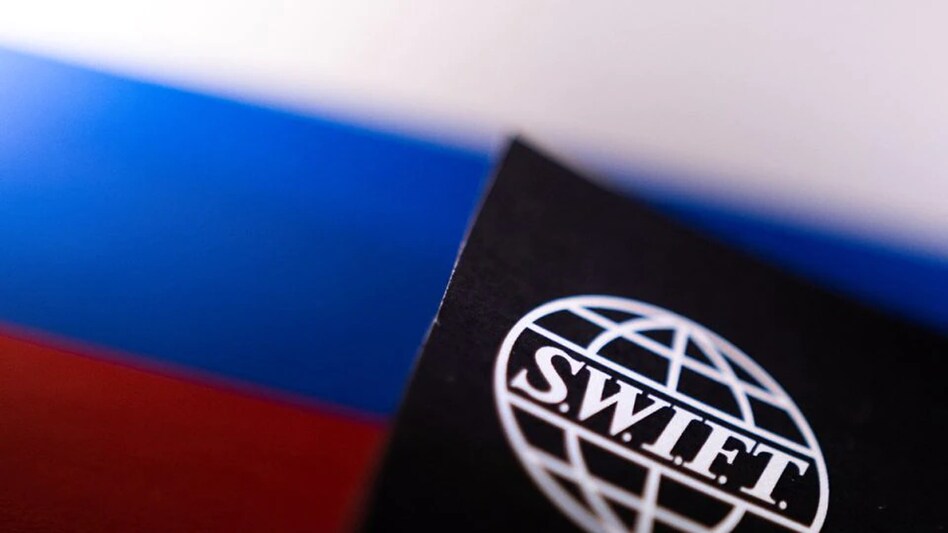Swift logo is placed on a Russian flag are seen in this illustration taken, Bosnia and Herzegovina, February 25,2022. (Photo: Reuters) Swift logo is placed on a Russian flag are seen in this illustration taken, Bosnia and Herzegovina, February 25,2022. (Photo: Reuters)