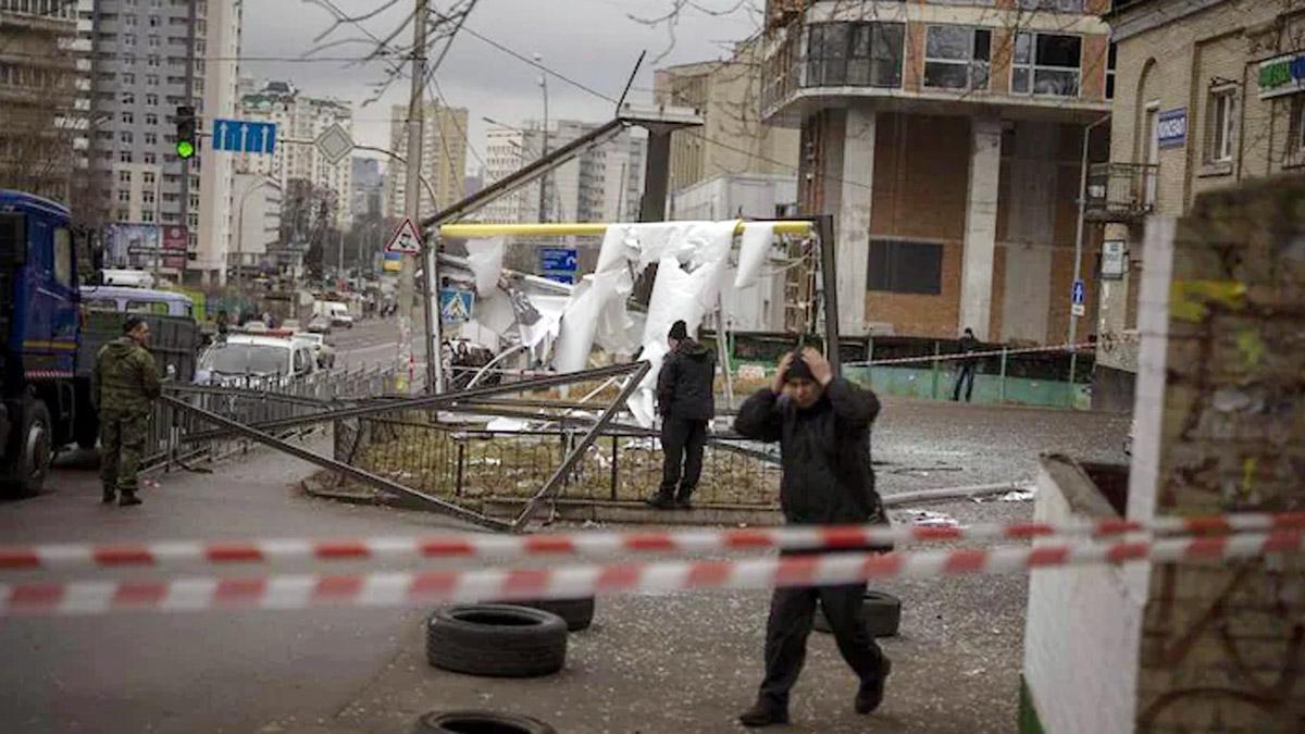 Police officers inspect area after an apparent Russian strike in Kyiv Ukraine. (Image: AP) Police officers inspect area after an apparent Russian strike in Kyiv Ukraine. (Image: AP)