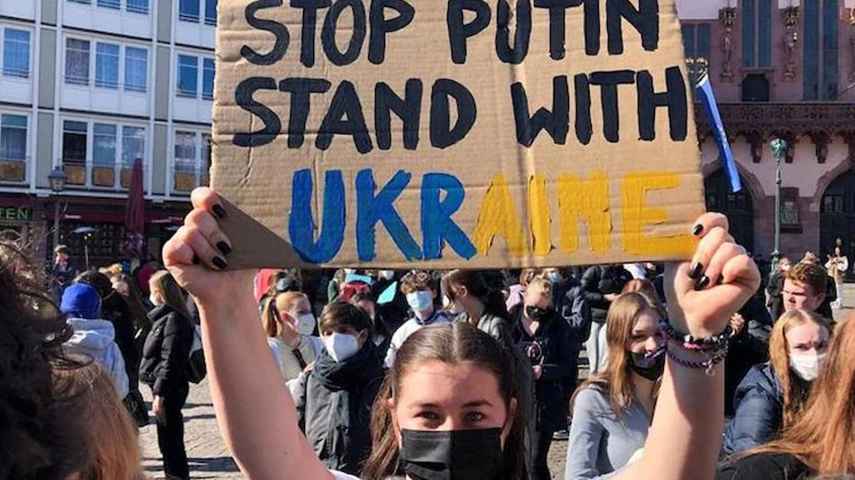 A protester holds a placard during a rally against the Russian invasion of Ukraine in Germany. (Image: Reuters) A protester holds a placard during a rally against the Russian invasion of Ukraine in Germany. (Image: Reuters)