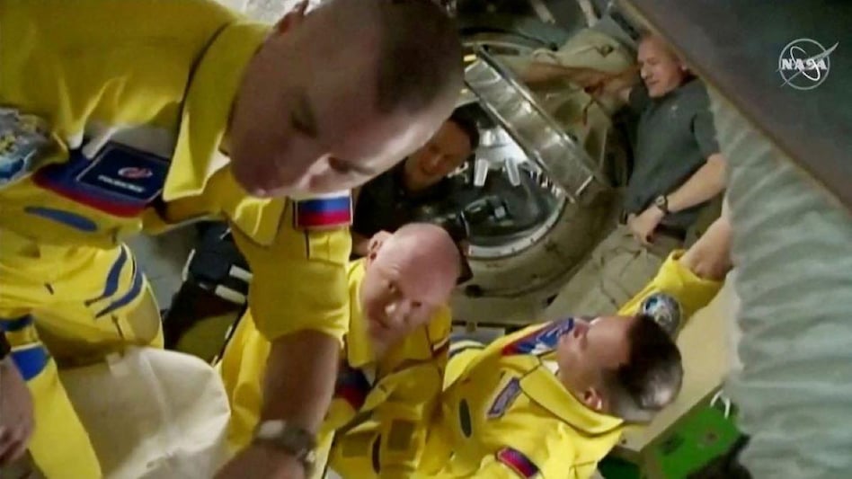 Russian cosmonauts Oleg Artemyev, Denis Matveev and Sergey Korsakov arrive wearing yellow and blue flight suits at the International Space Station. (Image: Reuters) Russian cosmonauts Oleg Artemyev, Denis Matveev and Sergey Korsakov arrive wearing yellow and blue flight suits at the International Space Station. (Image: Reuters)