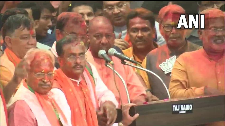 The UP chief minister was sprayed with gulal (dry colour) by state party president Swatantra Dev Singh and others to celebrate the party's victory in the elections. (Photo: ANI) The UP chief minister was sprayed with gulal (dry colour) by state party president Swatantra Dev Singh and others to celebrate the party's victory in the elections. (Photo: ANI)