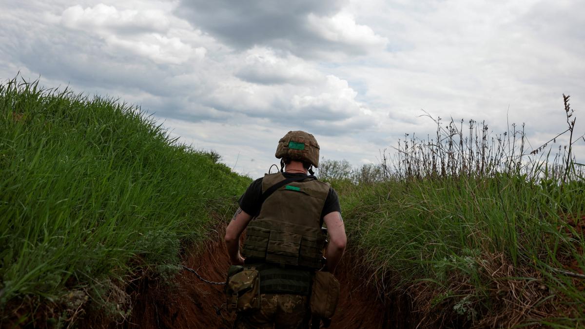 A Ukrainian serviceman walks in a trench, as Russia's attack on Ukraine continues, in Donetsk Region, Ukraine