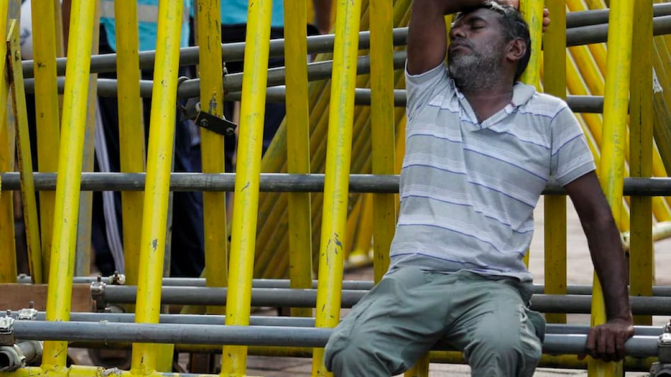 A man sleeps on a metal barrier on the 4th consecutive day of protests against Sri Lankan President Gotabaya Rajapaksa in front of the Presidential Secretariat, amid the country's economic crisis. (Photo: Reuters) A man sleeps on a metal barrier on the 4th consecutive day of protests against Sri Lankan President Gotabaya Rajapaksa in front of the Presidential Secretariat, amid the country's economic crisis. (Photo: Reuters)